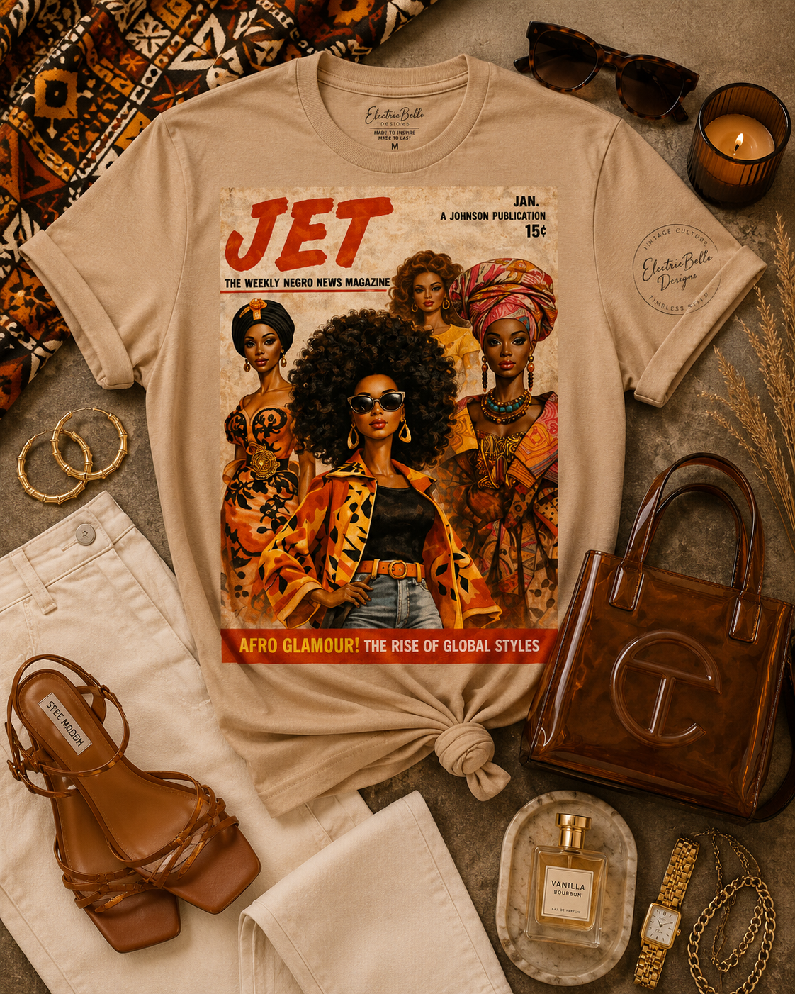 Tan Afro Glamour graphic tee styled with cream denim, brown strappy heels, a brown jelly bag, gold jewelry, tortoiseshell sunglasses and African print accents.