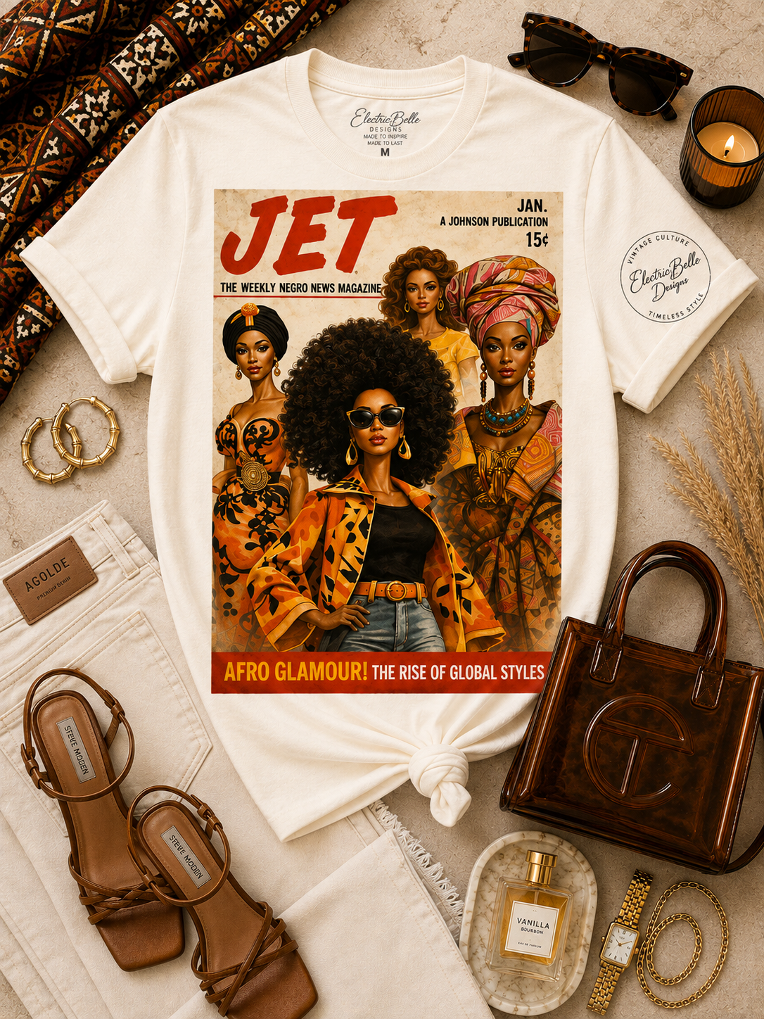 Vintage white Afro Glamour graphic tee styled with cream denim, brown strappy heels, a brown jelly bag, gold jewelry, tortoiseshell sunglasses and African print accents.