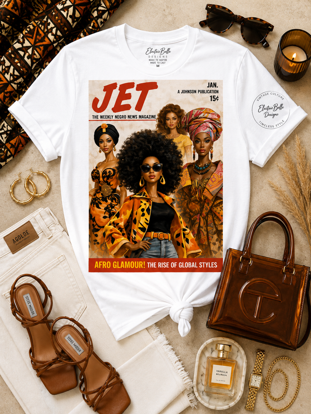 White Afro Glamour graphic tee styled with cream denim, brown strappy heels, a brown jelly bag, gold jewelry, tortoiseshell sunglasses and African print accents.